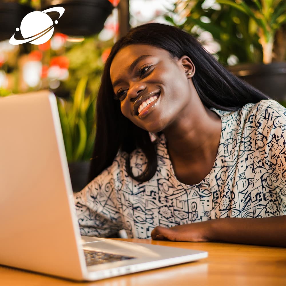 Person smiling while using laptop